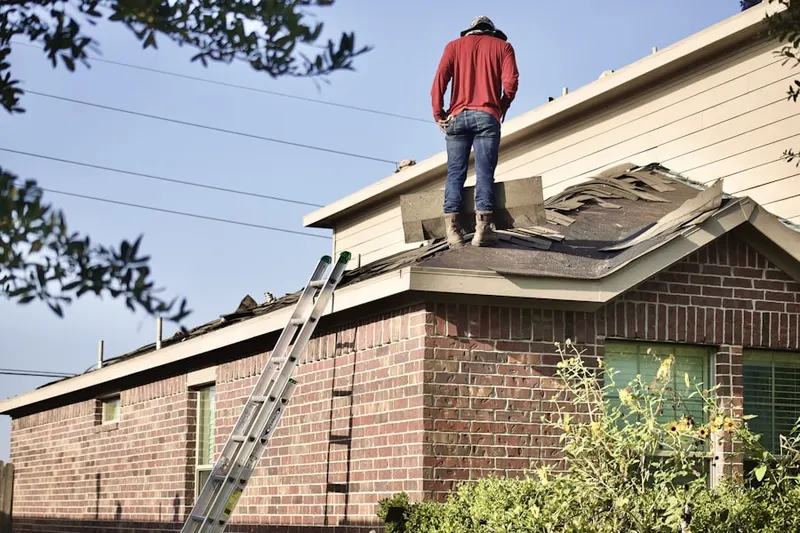 Professional roofer working on a residential roof in Crest View